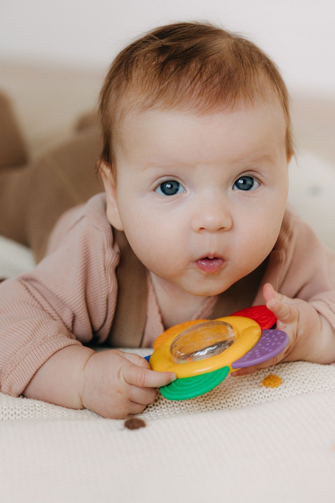 Curious baby exploring a colourful toy