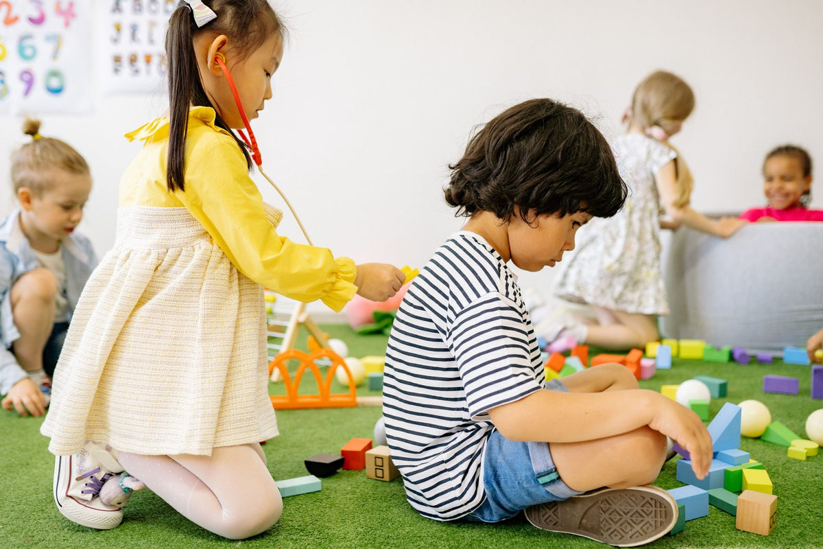 Children playing with toys on a preschool floor