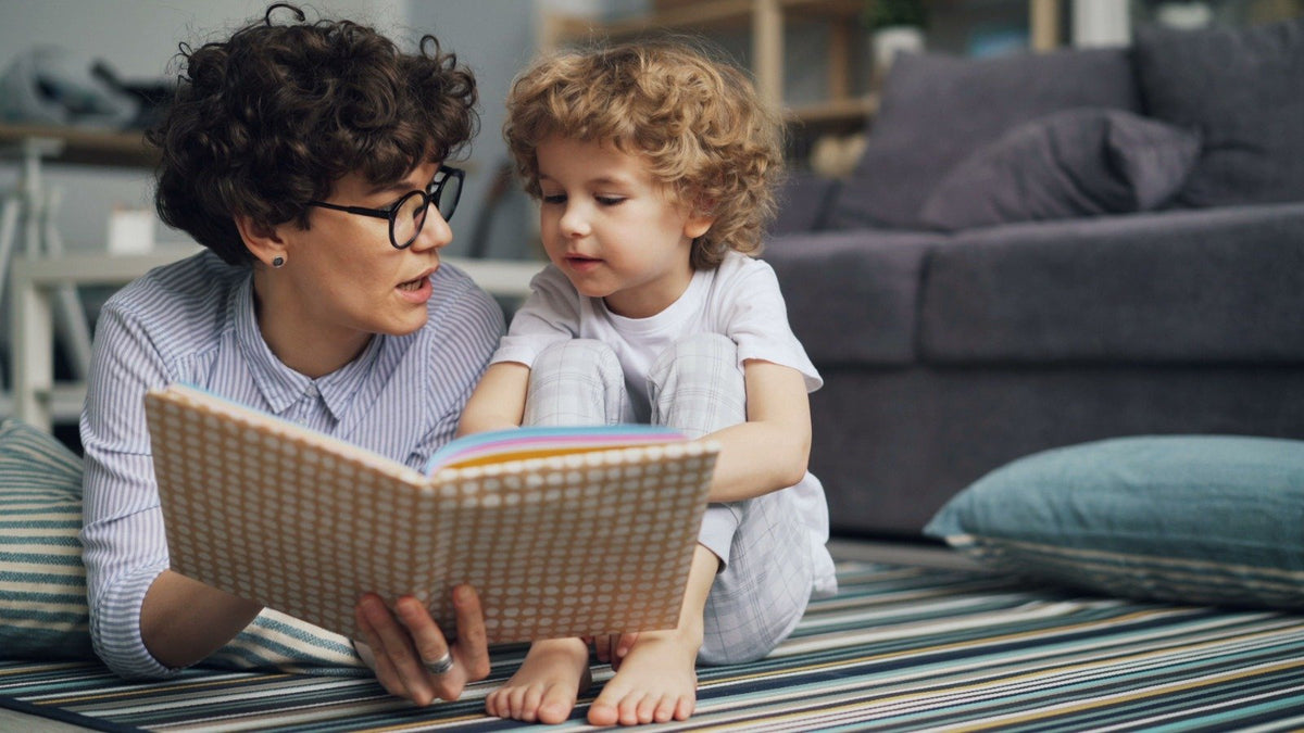 Mother reading a picture book aloud to her young son